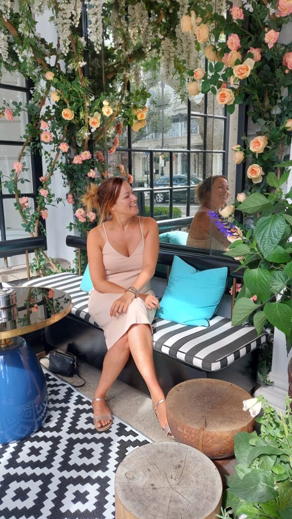 A girl on a bench, taking a break from shopping wining and dining